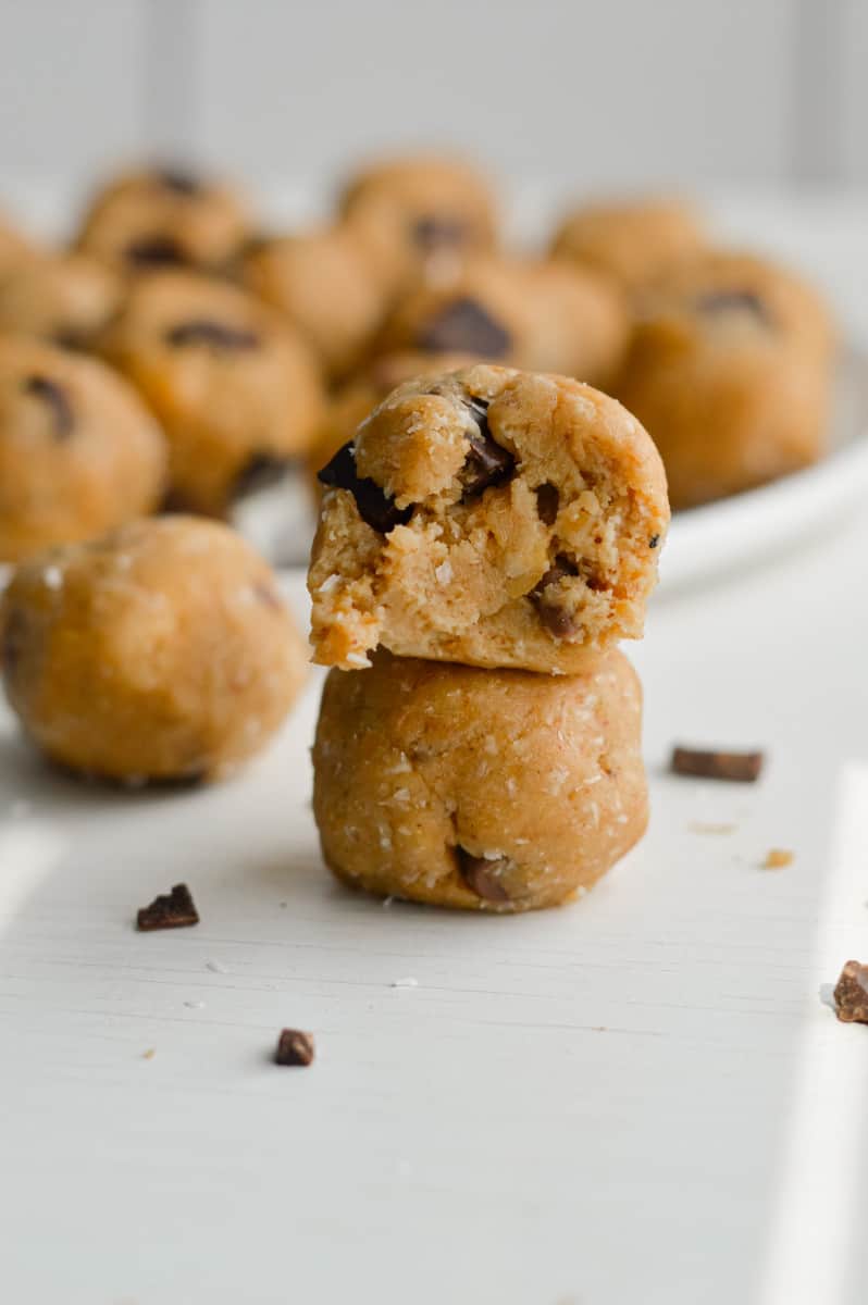 Two cookie dough protein balls stacked.