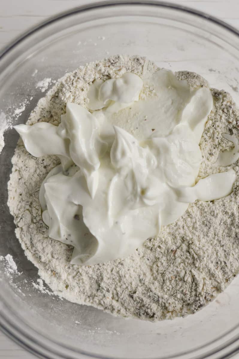 Mixing greek yogurt with flour.