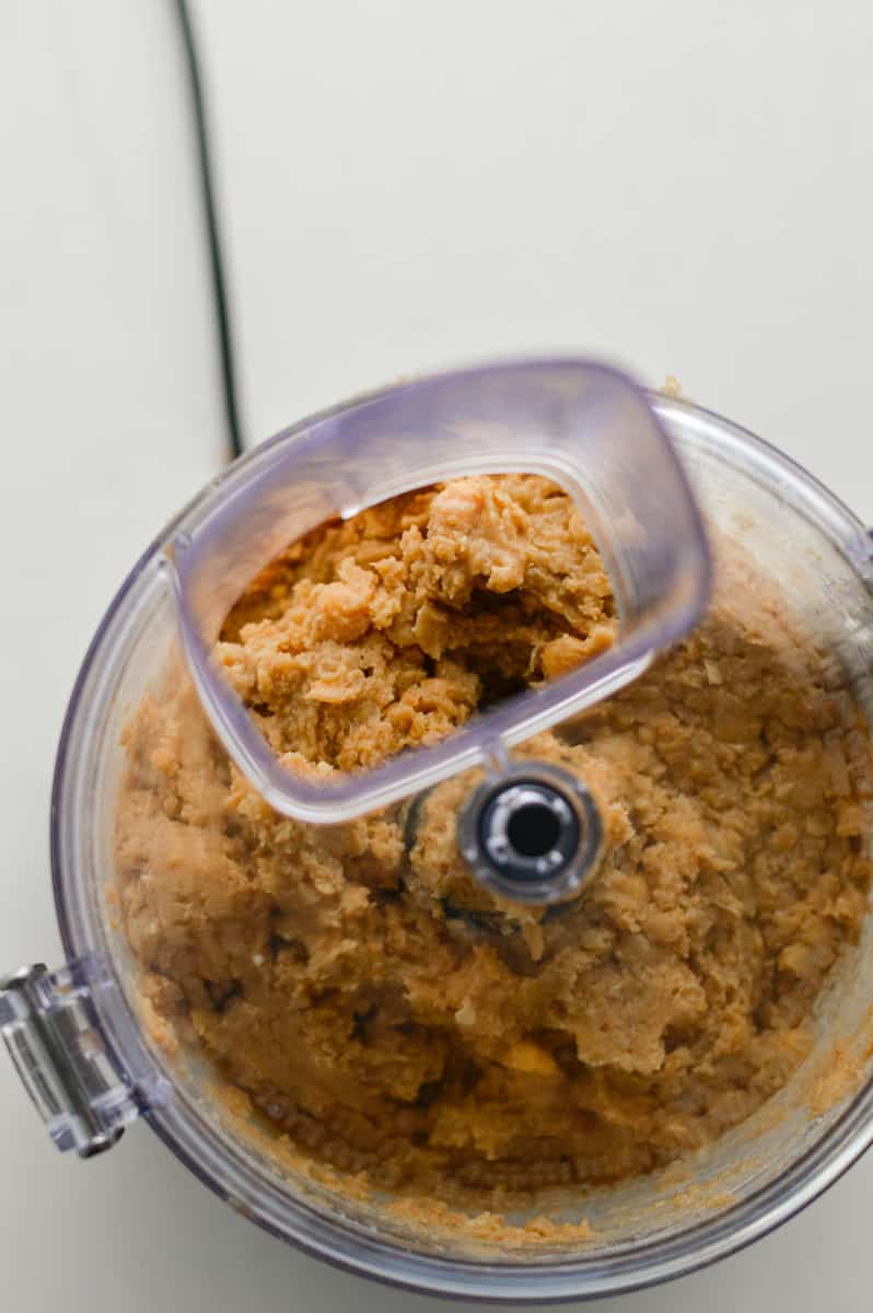Blending chickpea cookie dough in a food processor.