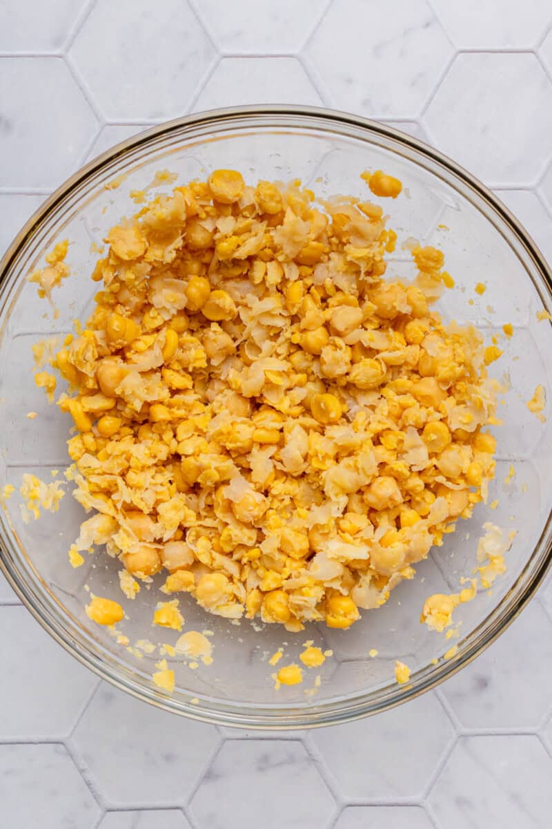 Smashed chickpeas in a bowl.