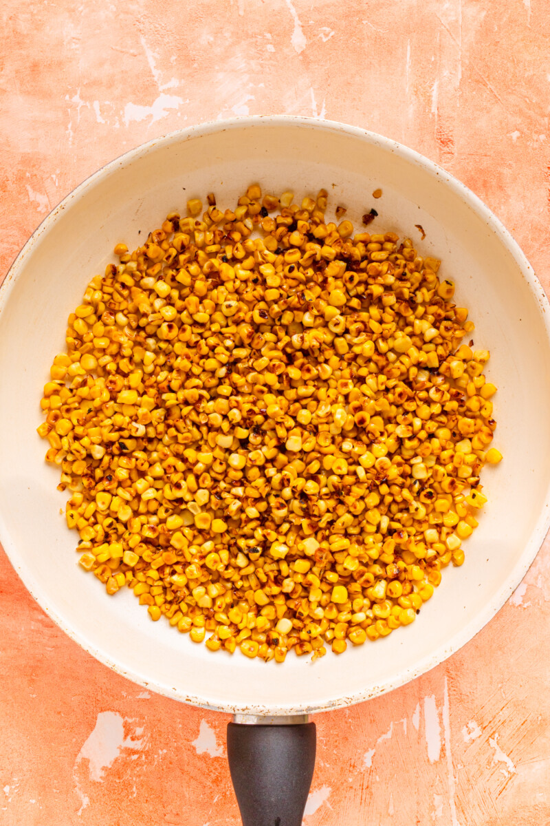 Corn being charred on a pan.