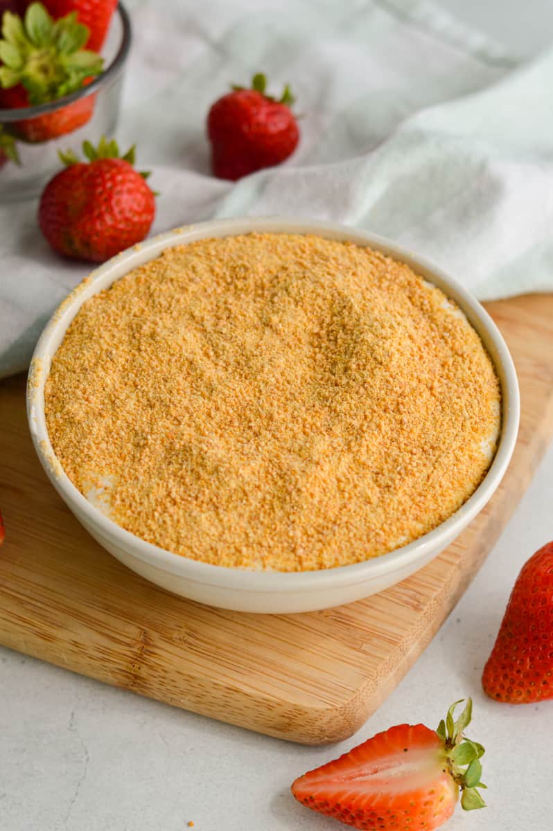 Topping cheesecake dip with graham cracker crumbs.