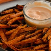 Plate of air fryer carrot fries served with sriracha mayo.