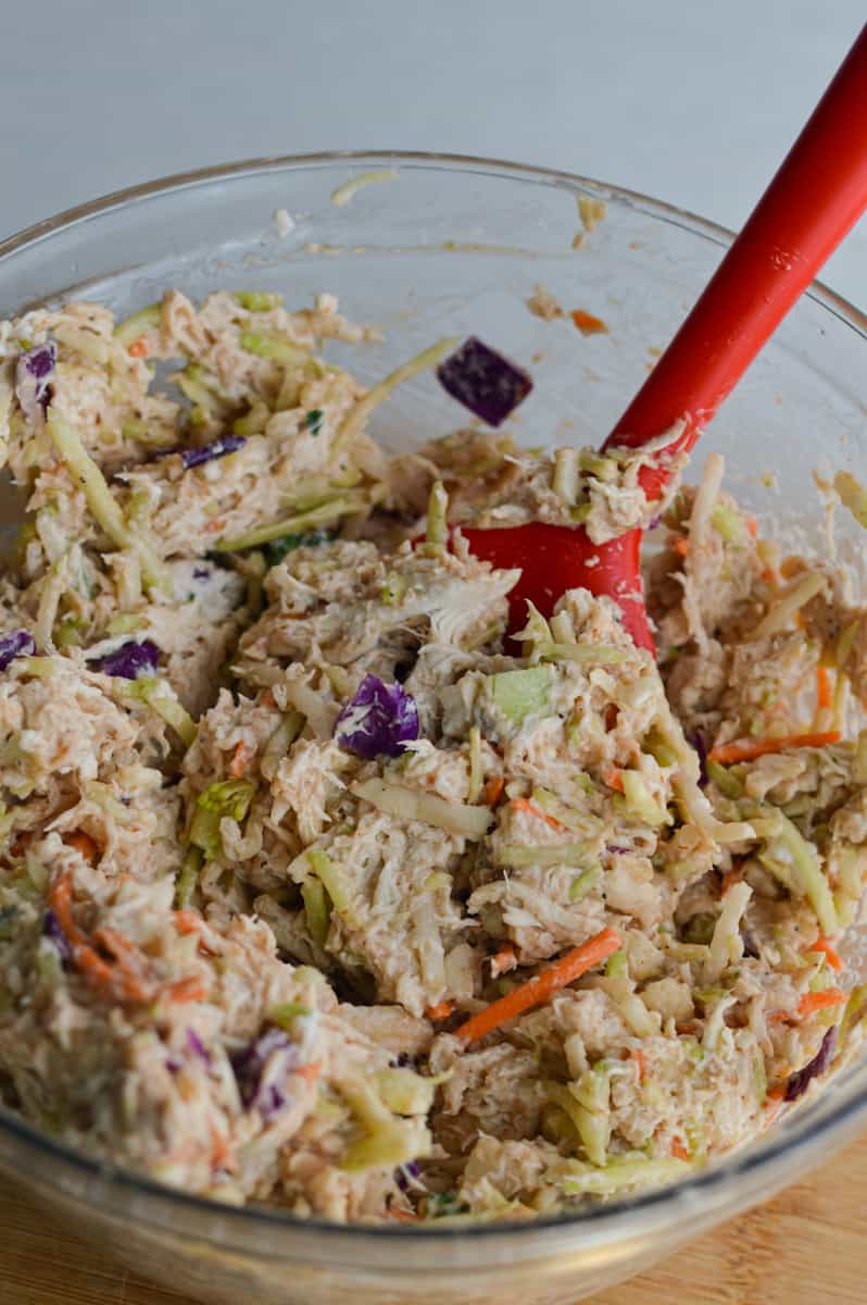 Mixing 5 ingredient chicken salad until well combined.