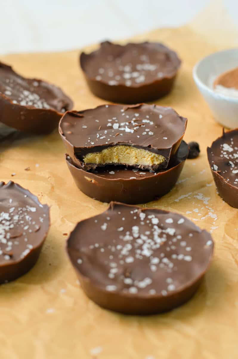 Stack of protein peanut butter cups with a bite taken out of the top cup.