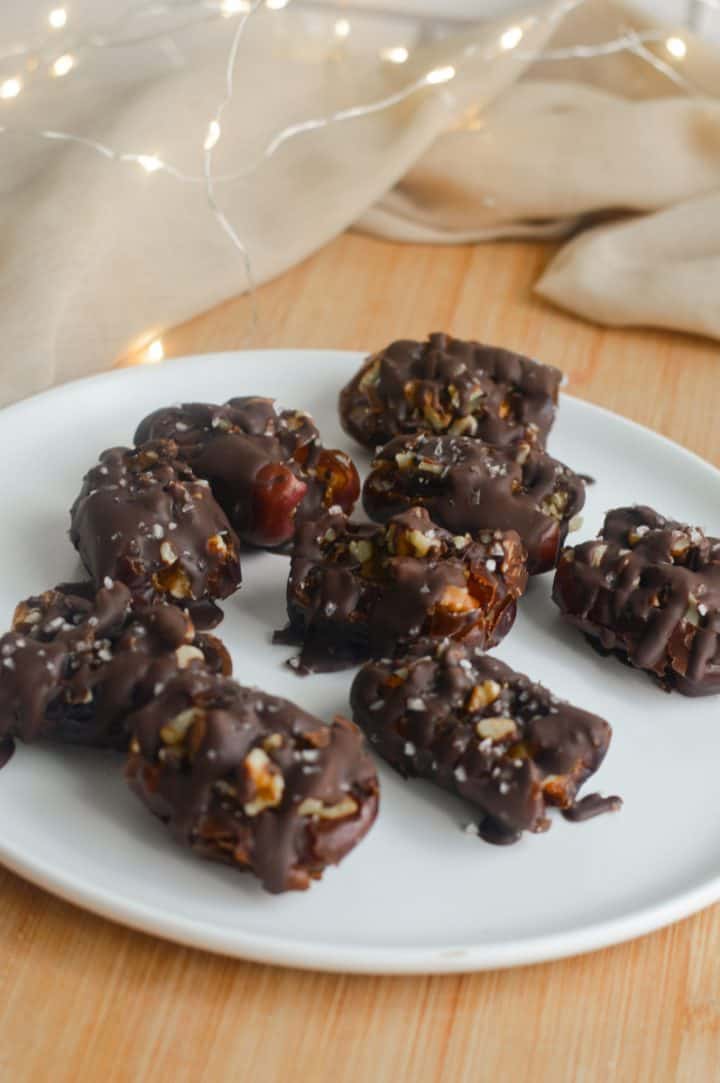 Chocolate covered dates on a plate.