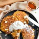 Birds eye of pumpkin protein pancakes with whipped cream, slivered almonds and maple syrup.