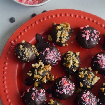 No bake chocolate truffles on a red plate.
