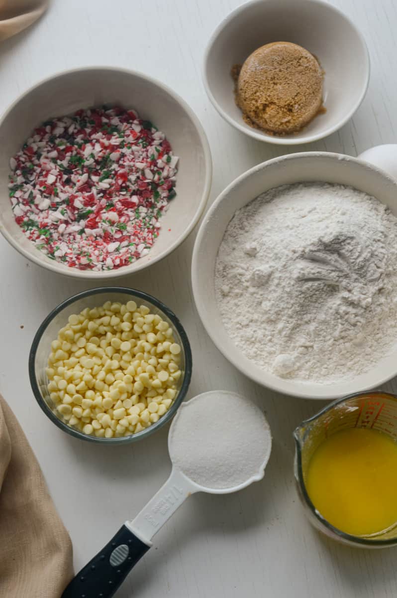 Ingredients for white chocolate peppermint cookies in bowls.