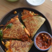 Air fryer quesadillas served with salsa, guacamole and sour cream.