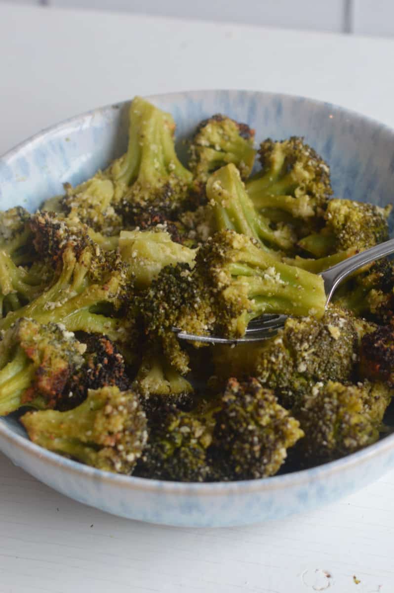 Air fryer broccoli in a bowl with a fork.