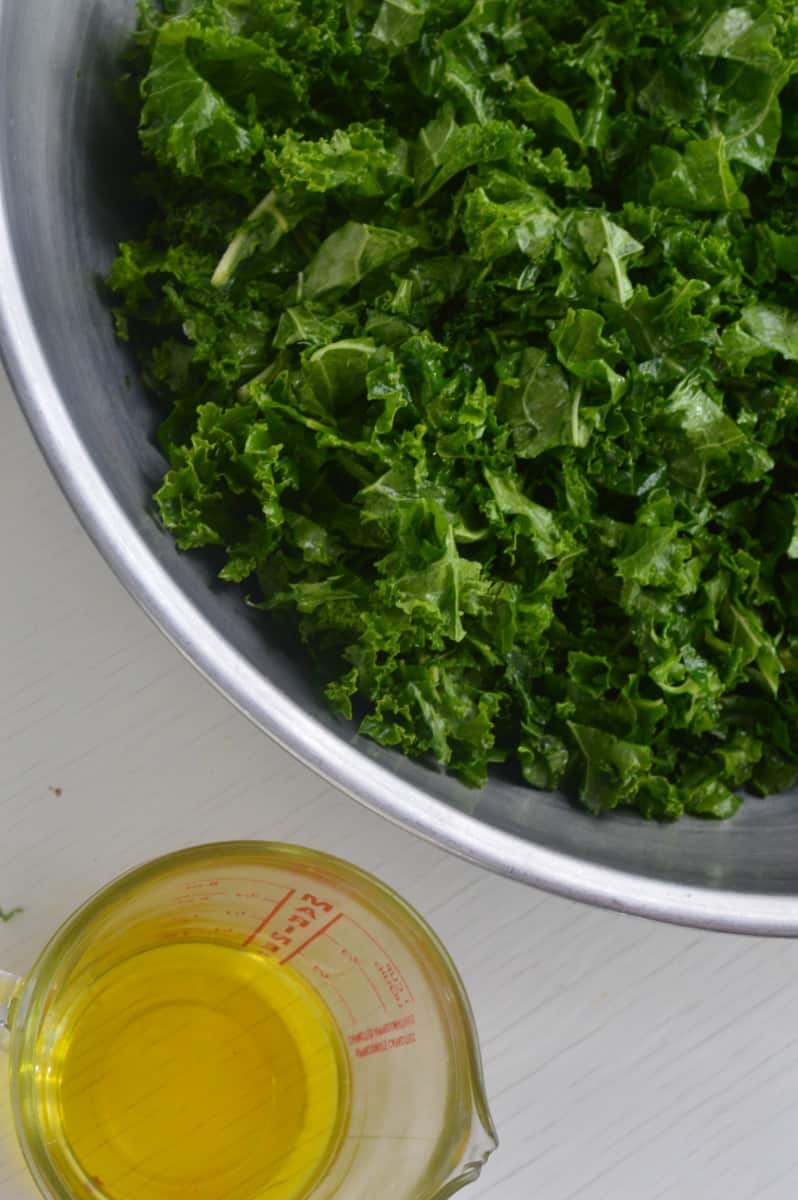 Massaging kale with olive oil and salt.