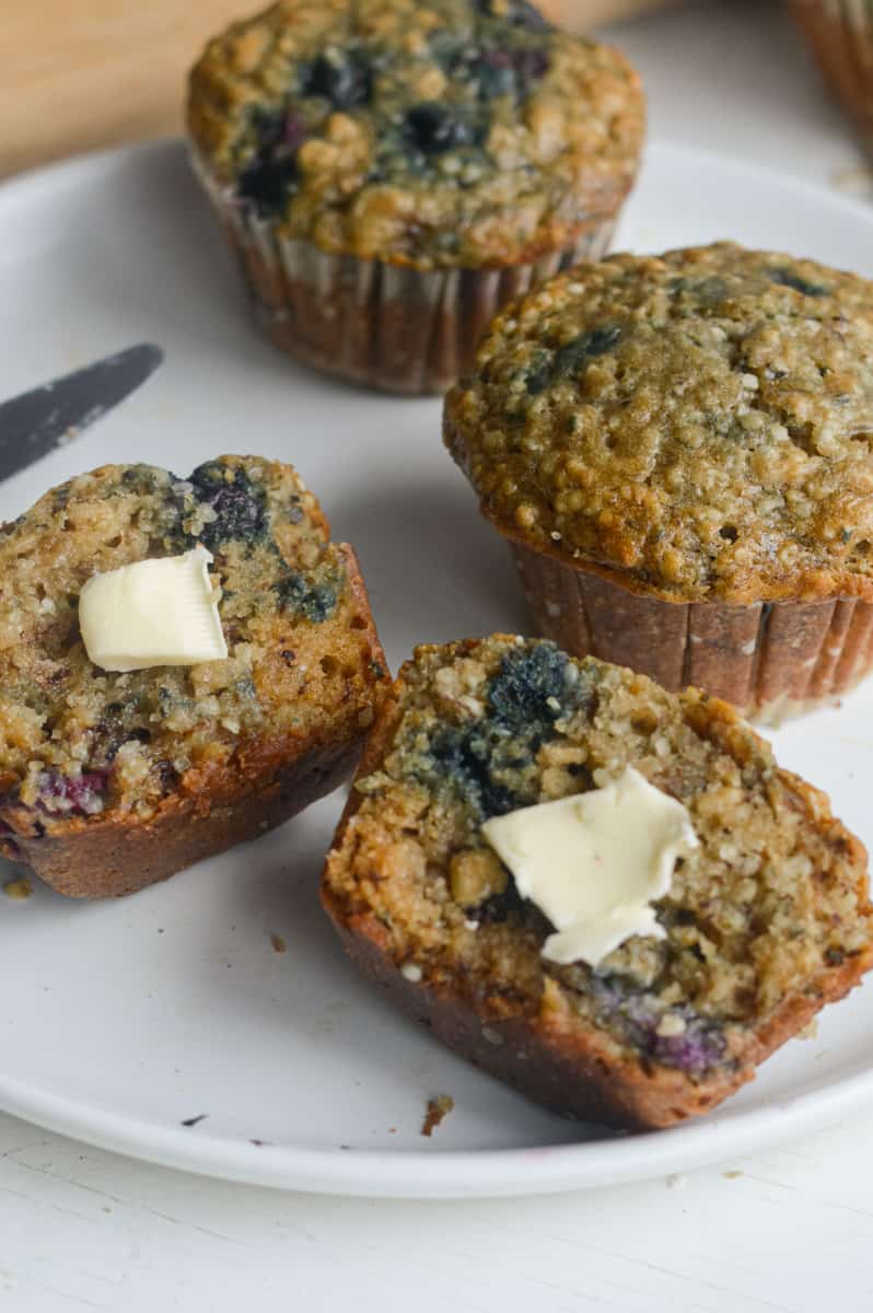 Banana blueberry oatmeal muffins served with butter.