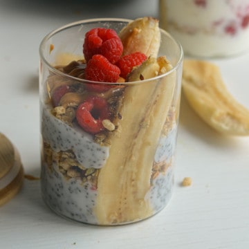 Greek yogurt and granola topped with raspberries.