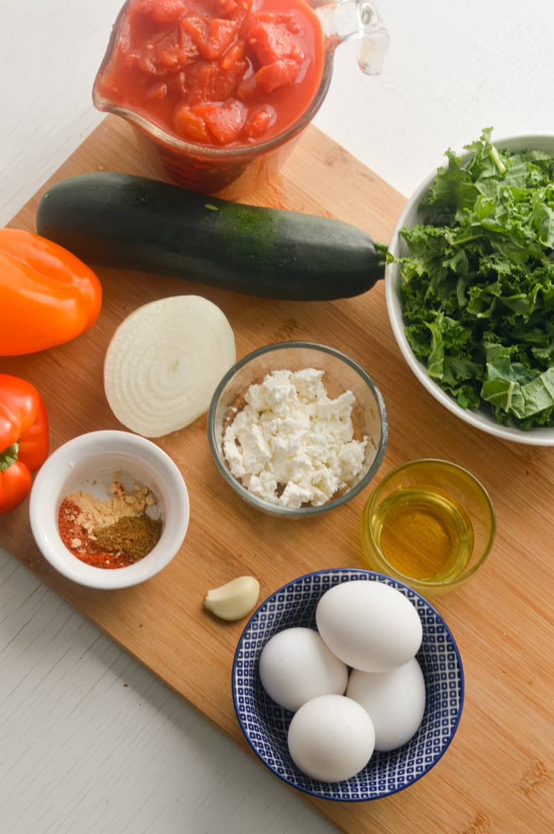 Ingredients for Moroccan shakshuka, including veggies, feta and eggs.