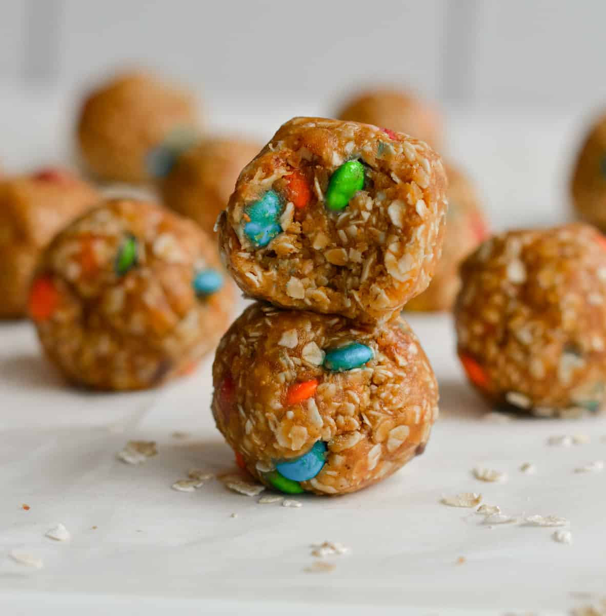 Two 3-ingredient peanut butter oatmeal balls stacked on top of each other.