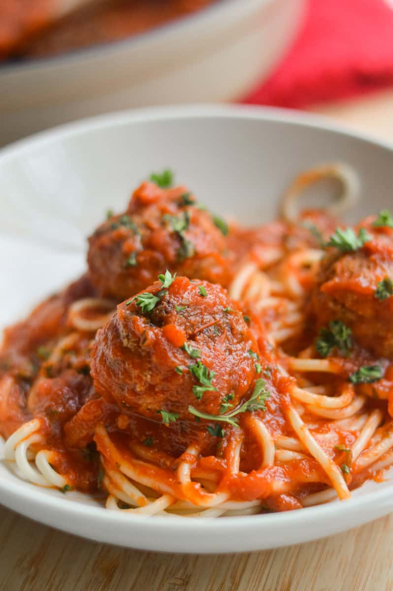Serving tofu meatballs with tomato sauce and pasta.
