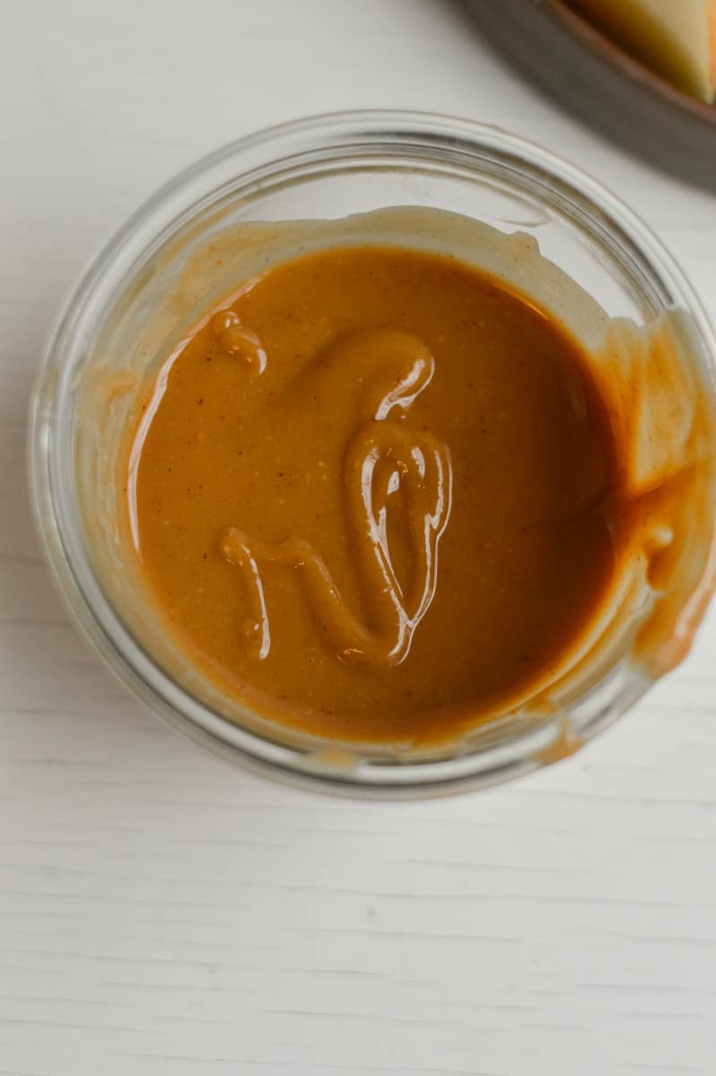 Storing peanut butter caramel in a glass jar.