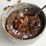 Taking a spoonful of chocolate protein mug cake.