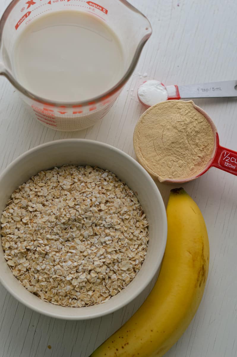 Ingredients for protein powder pancakes including oats, milk and protein powder.