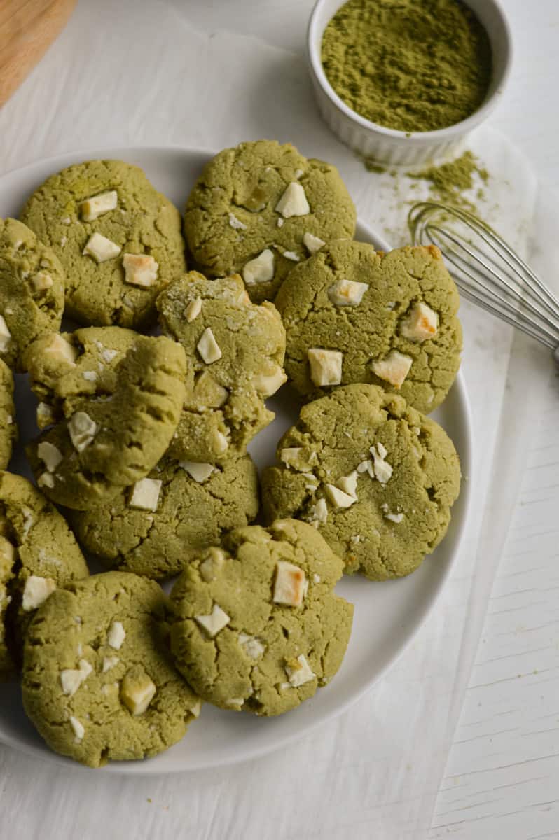 Birds eye view of matcha white chocolate cookies on a plate.