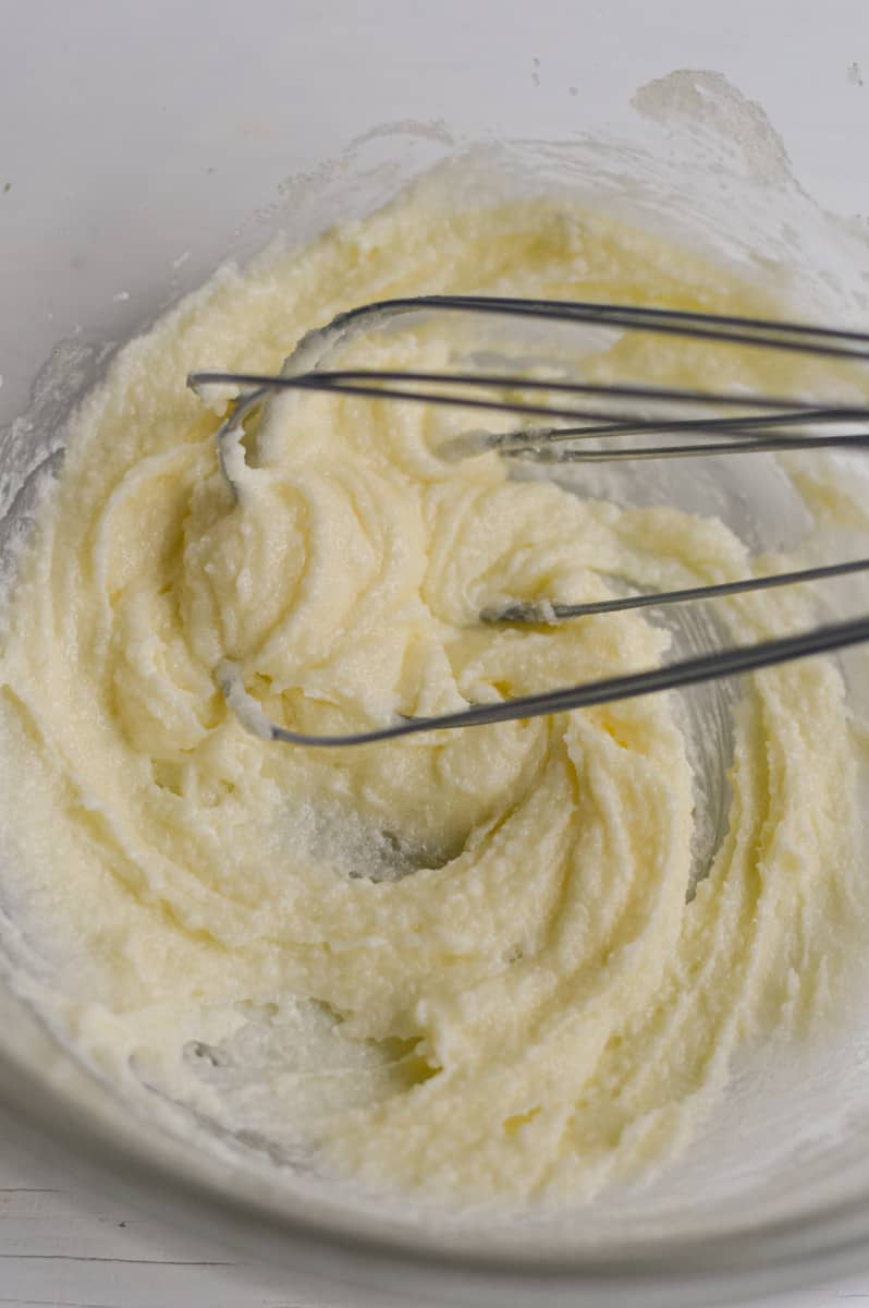 Whisking together butter and sugar.