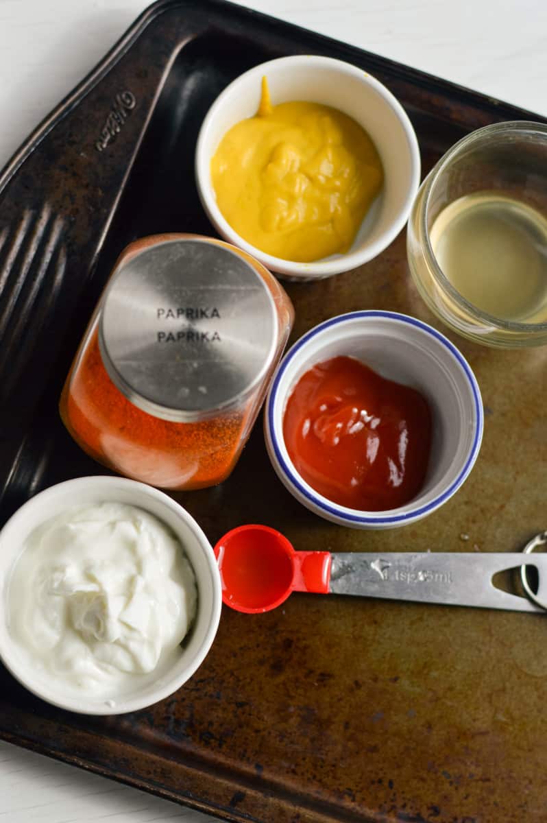 Ingredients for healthy big mac sauce including mayo, yogurt, ketchup and mustard.