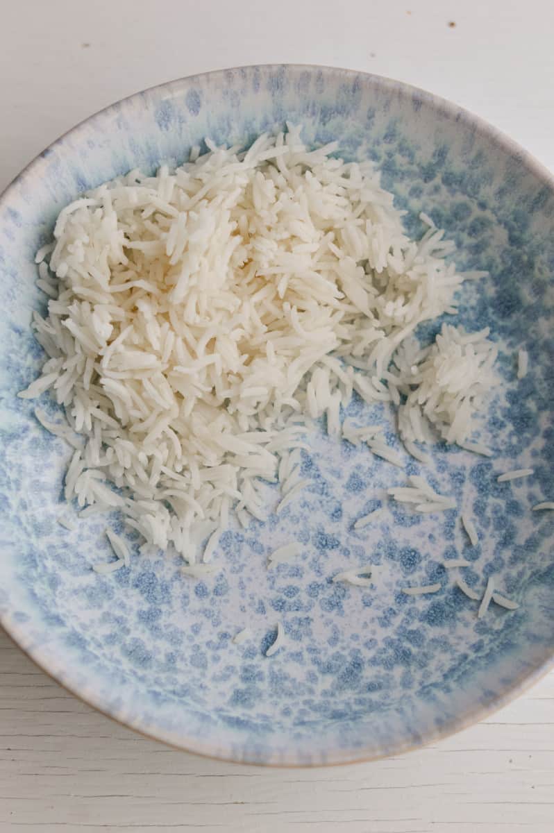 Adding rice to a bowl.