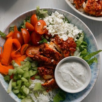 Buffalo chicken rice bowls served with ranch dressing.
