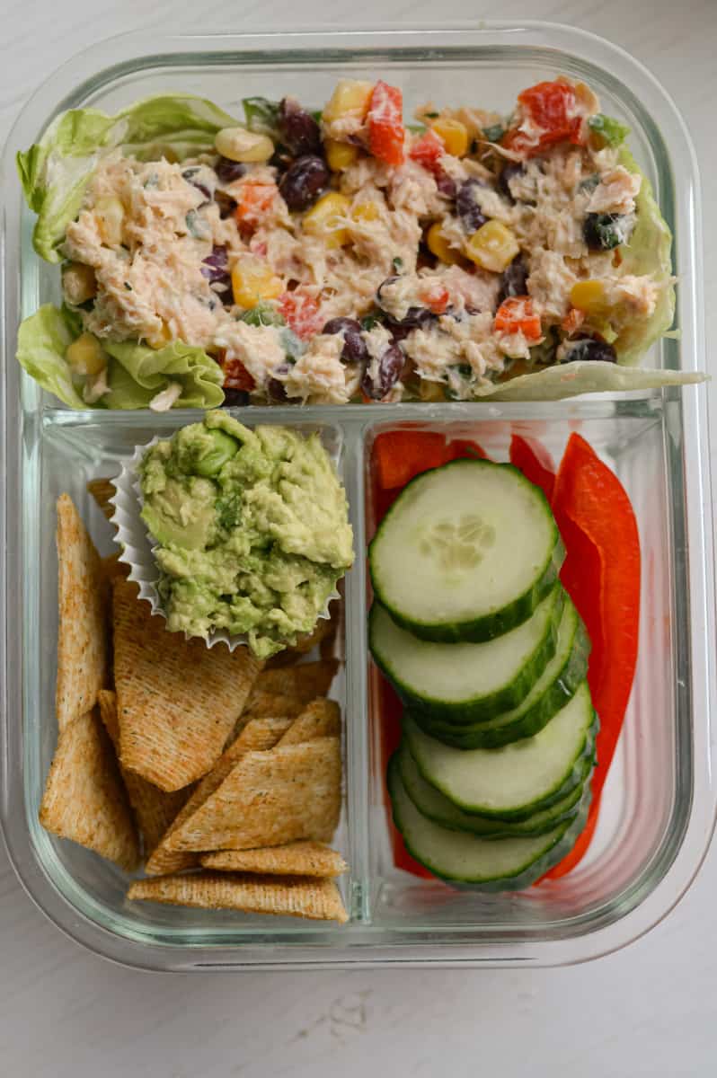 Serving Mexican tuna salad with crackers, guacamole and veggies.