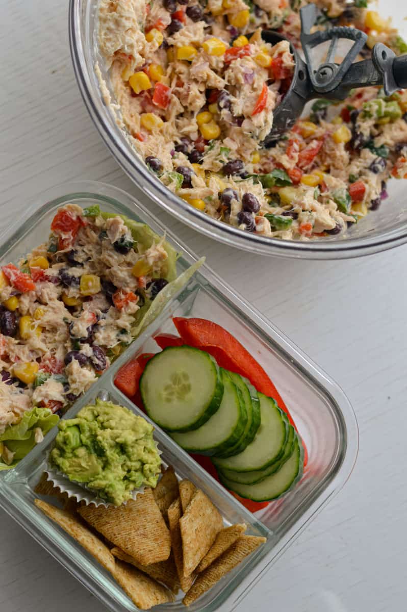 Packing Mexican tuna salad in a lunch container.