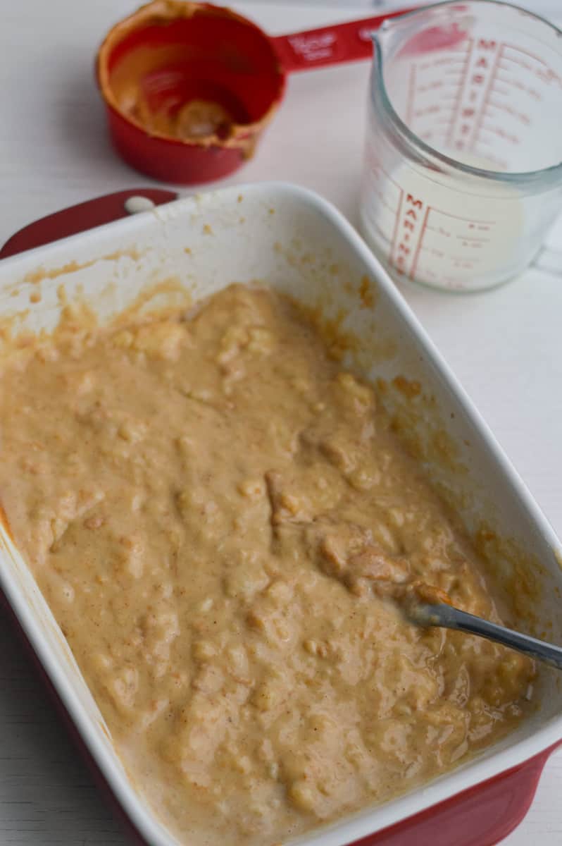 Mixing peanut butter with mashed bananas.