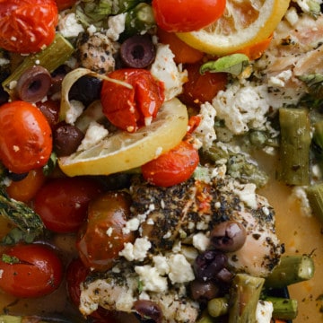 Baked chicken with feta, veggies and lemon slices.