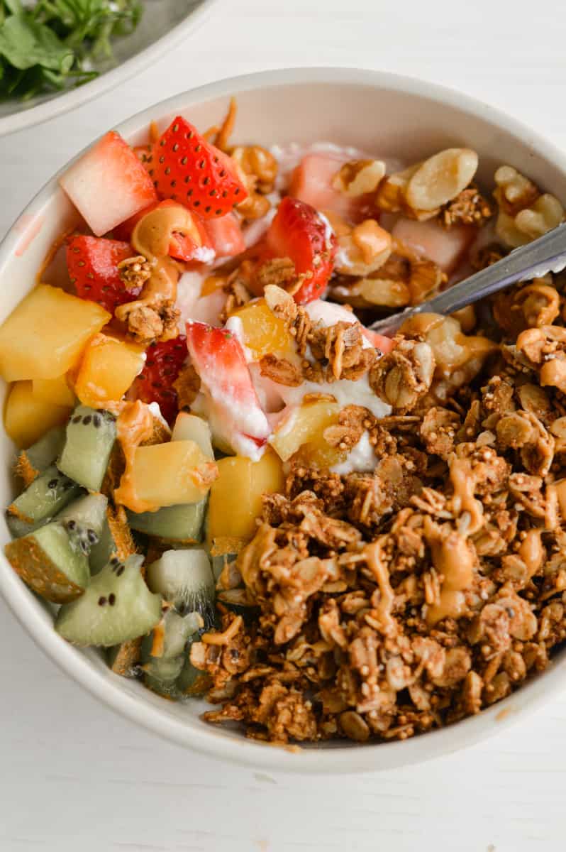 Spoonful of sweet cottage cheese bowl with granola and fruit.