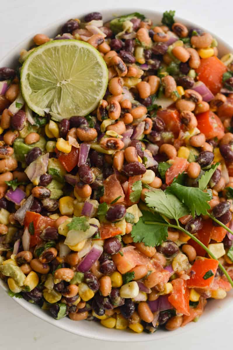 Vegan bean salad served with a lime slice.
