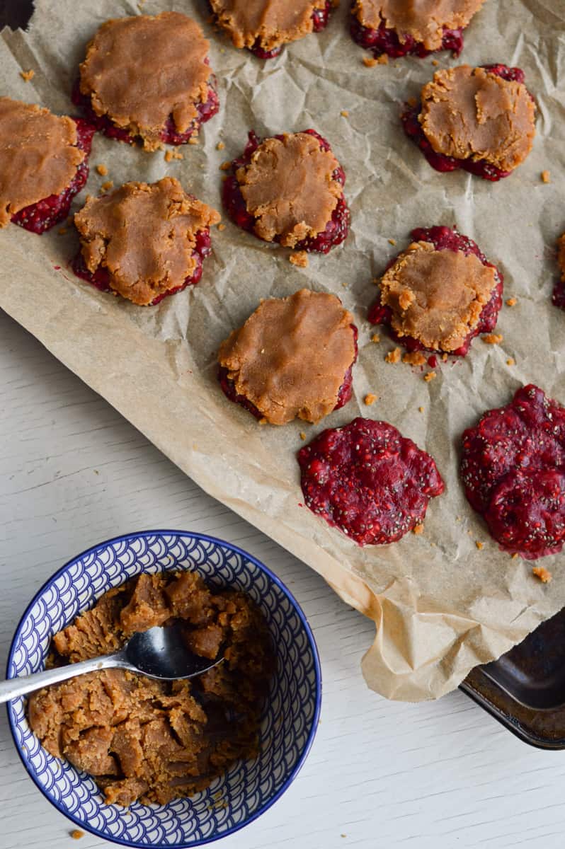 Topping jam bites with peanut butter.
