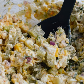 Close up of egg salad with pickles.