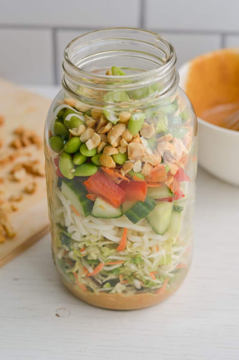 Open jar with peanut salad.