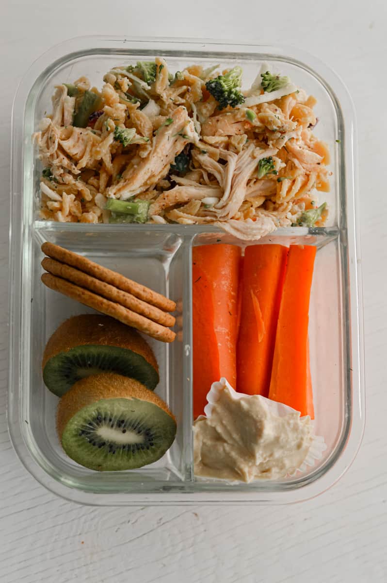 Protein pasta salad in an adult lunchable with fruit, veggies, and crackers.