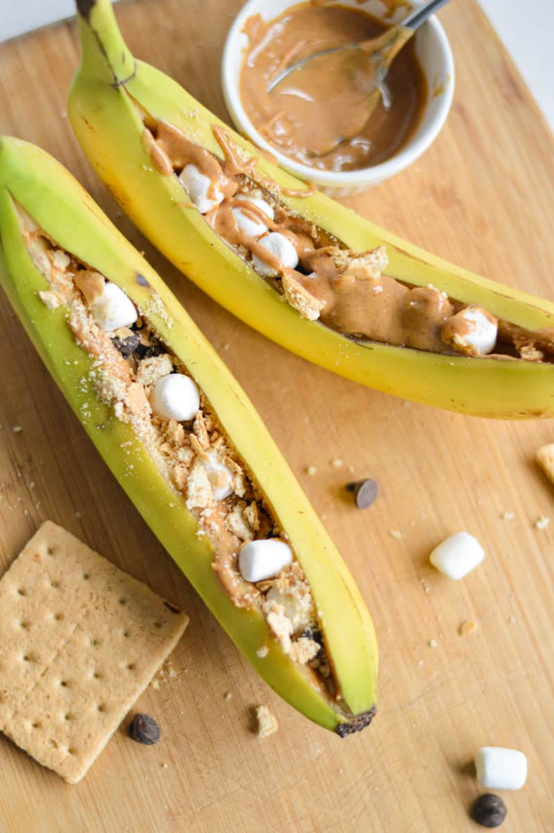 Stuffing bananas with peanut butter, marshmallows and chocolate chips.