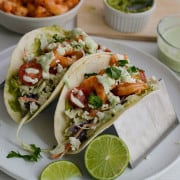 Plate with two air fryer shrimp tacos.