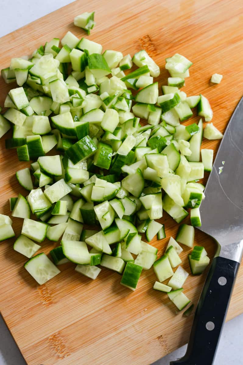 Finely dicing cucumbers.