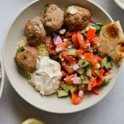 Mediterranean grain bowls with greek turkey feta meatballs, cucumber salad, tahini yogurt and pita.