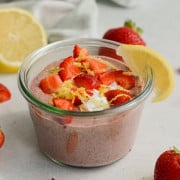 Strawberry lemonade blended chia pudding topped with strawberries, yogurt and a lemon slice.
