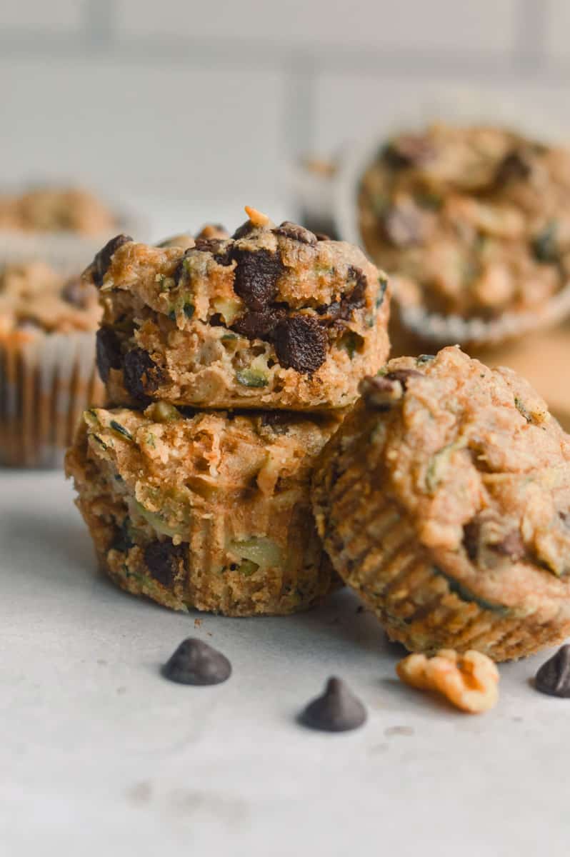 Pile of vegan zucchini muffins with chocolate chips.