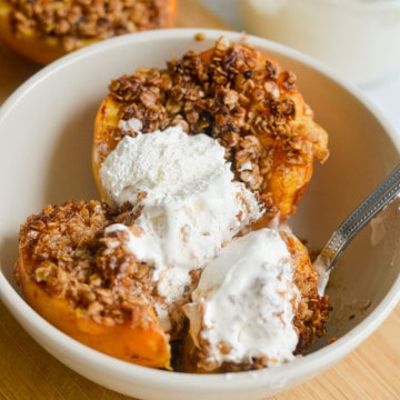 Eating air fryer peaches topped with whipped cream.