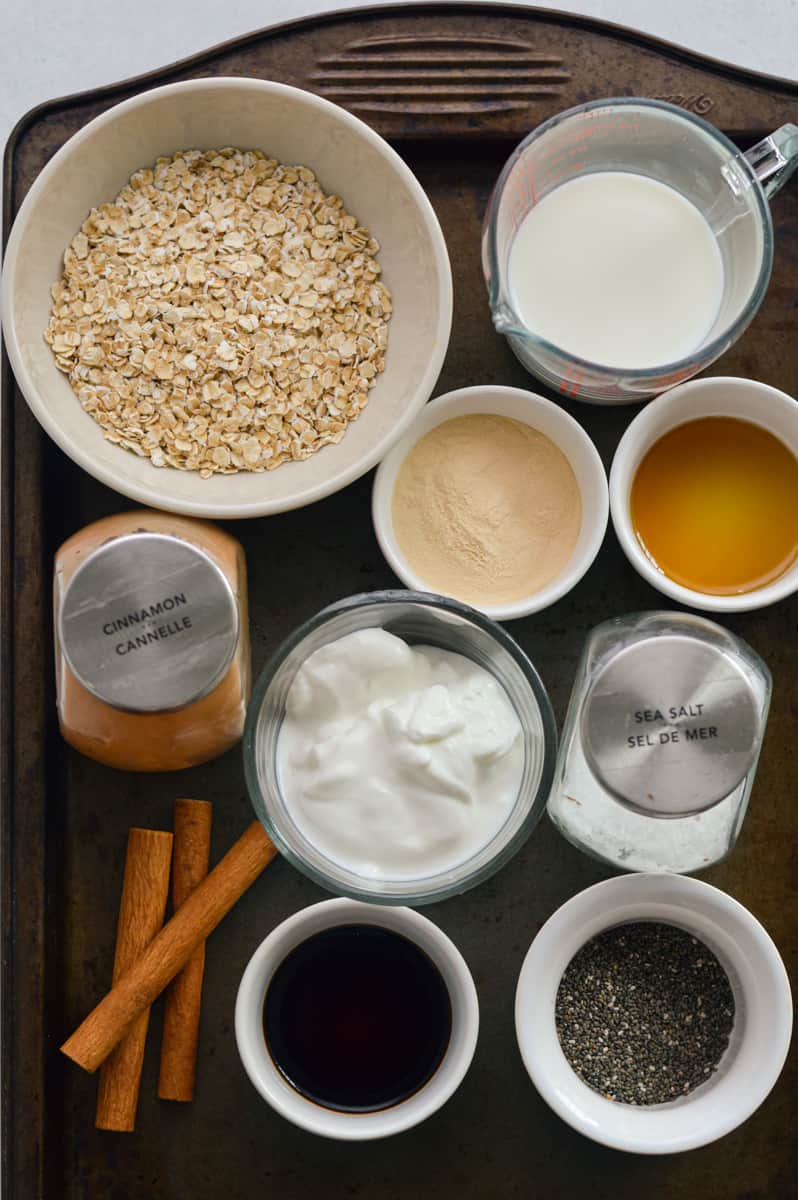 Ingredients including oats, Greek yogurt, milk, chia seeds, cinnamon, maple syrup, protein powder and salt.
