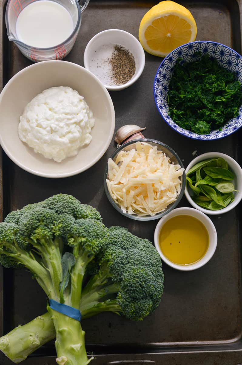Ingredients including broccoli, cottage cheese, parmesan, basil, olive oil, lemon juice and spinach.