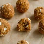 Tray of pumpkin protein balls, with a bite out of one.
