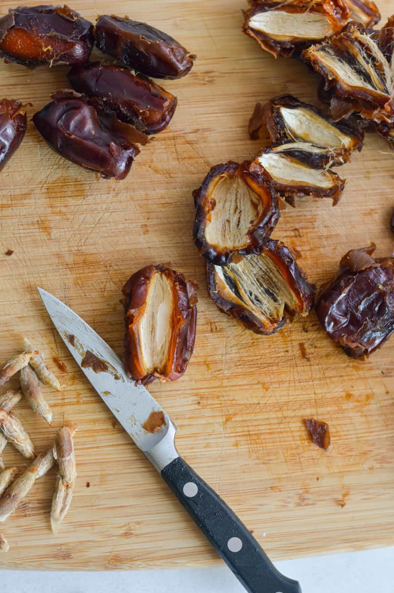 Slicing dates in half and removing pits.